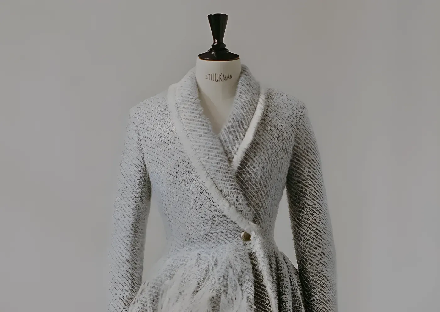 A knitted luxury garment on a tailor’s mannequin